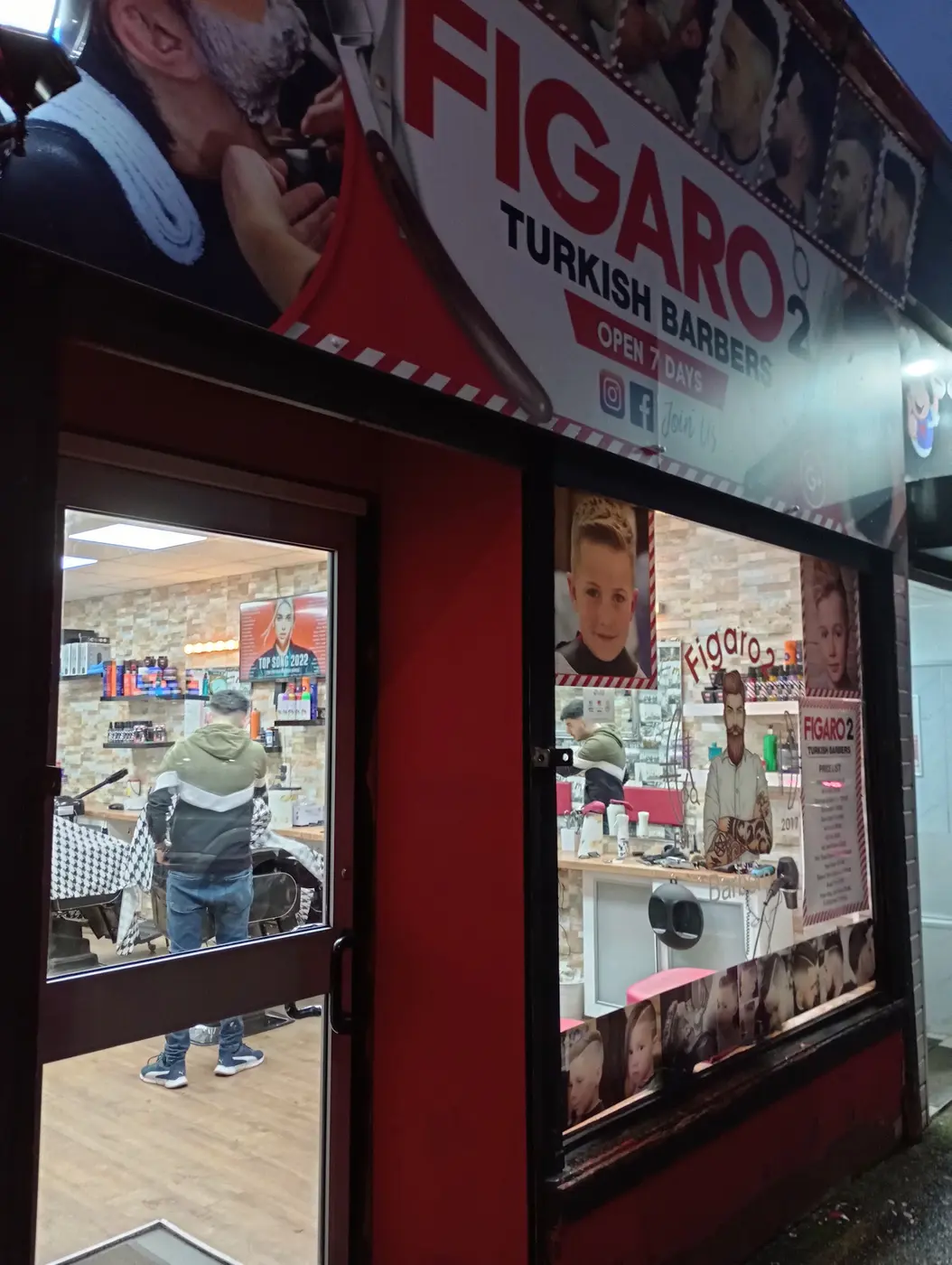 Figaro 2 Turkish Barbers shopfront at night, red and white sign lit above the door
